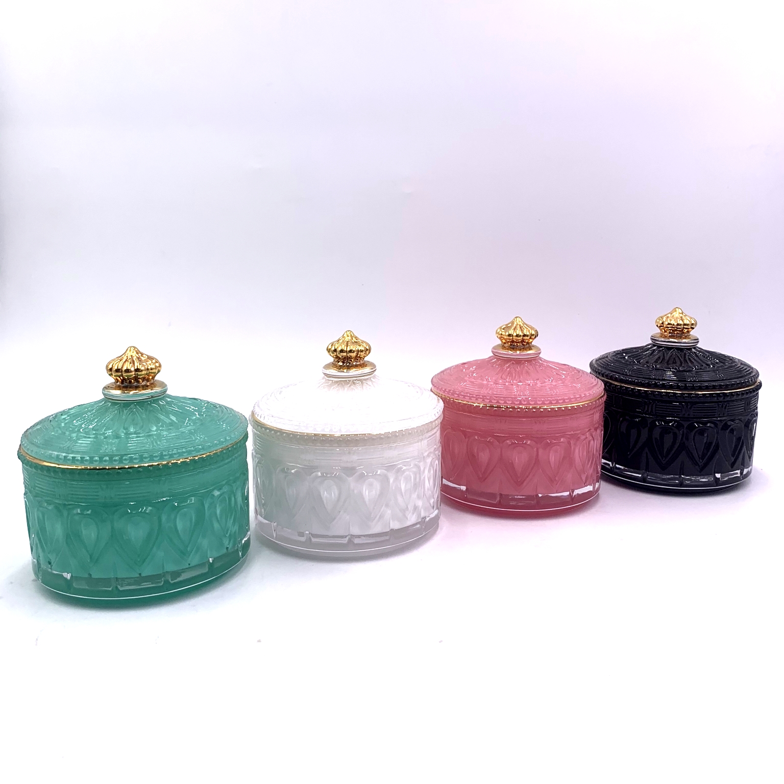 colored glass candle jar with gold rim and knob